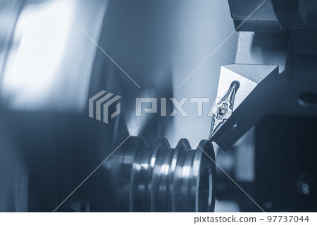 The CNC lathe machine V-groove cutting operation. The CNC lathe machine V-groove cutting operation. 97737044