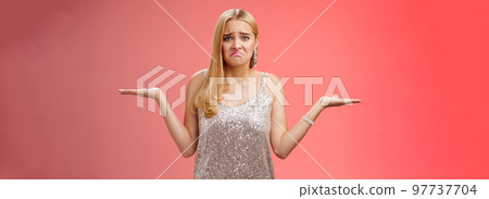 Upset clueless frustrated blond european young girl in glittering silver evening dress grimacing pouting sad shrugging raise hands sideways dismay doubtful, no idea what do, complicated decision Upset clueless frustrated blond european young girl in glittering silver evening dress grimacing pouting sad shrugging raise hands sideways dismay doubtful, no idea what do, complicated decision 97737704