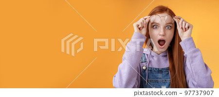 Omg no freakin way. Shocked emotional redhead girlfriend take off glasses speechless drop jaw gasping stunned wide eyes camera stare amazed found out shook secret standing orange background Omg no freakin way. Shocked emotional redhead girlfriend take off glasses speechless drop jaw gasping stunned wide eyes camera stare amazed found out shook secret standing orange background 97737907