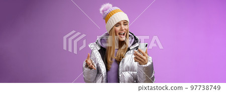 Bothered complaining dissatisfied cute blond girl yelling stupid smartphone standing unhappy recording audio message whining yelling mobile phone upset, standing purple background Bothered complaining dissatisfied cute blond girl yelling stupid smartphone standing unhappy recording audio message whining yelling mobile phone upset, standing purple background 97738749