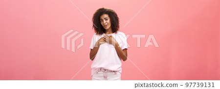 Oh you melt my heart so sweet. Touched and grateful good-looking charmed african american woman with curly hair in stylish outfit holding palms on heart sighing from delight and thankful feelings Oh you melt my heart so sweet. Touched and grateful good-looking charmed african american woman with curly hair in stylish outfit holding palms on heart sighing from delight and thankful feelings 97739131