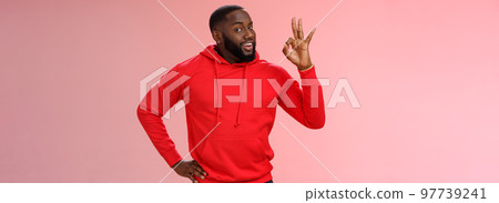 Guy hold everything under control assuring customer show okay sign. Portrait charismatic cheeky black bearded man say ok smiling assured confident you look perfect, standing pleased pink background 97739241