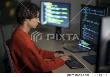 Young engineer working in the office at night 97739354