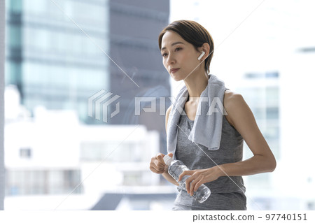 Woman resting after training hydration workout Woman resting after training hydration workout 97740151