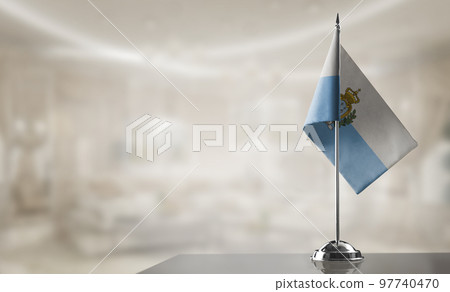 A small San Marino flag on an abstract blurry background A small San Marino flag on an abstract blurry background 97740470