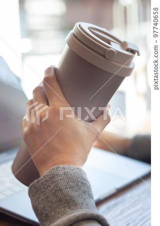 Woman hold thermos stainless steel bottle Woman hold thermos stainless steel bottle 97740658