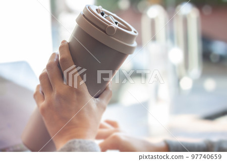 Woman hold thermos stainless steel bottle 97740659