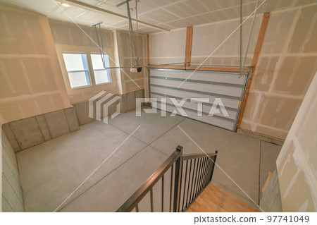 Interior of a garage with automatic sectional door operator machine 97741049