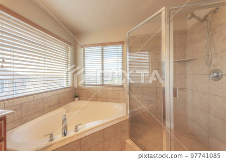 Corner bathtub and shower stall with ceramic tiles surround Corner bathtub and shower stall with ceramic tiles surround 97741085