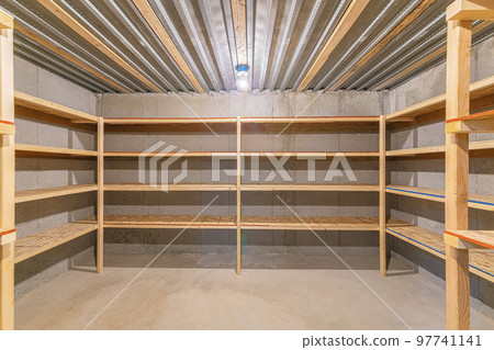 Unfinished food storage at the basement with concrete walls 97741141