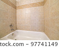 Alcove bathtub close up with brown ceramic tiles surround 97741149