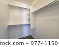 Small walk-in closet with corner vertical framed shelves 97741150