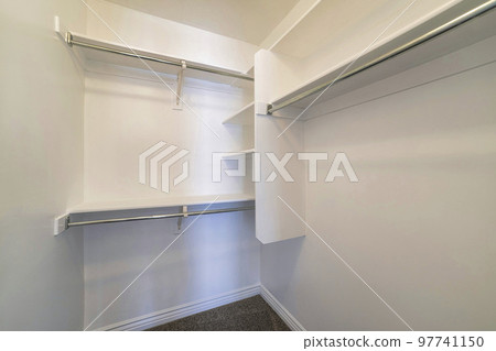 Small walk-in closet with corner vertical framed shelves 97741150