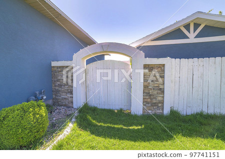 Wooden backyard gate with concrete arched entrance and stone veneer fence Wooden backyard gate with concrete arched entrance and stone veneer fence 97741151