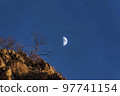 Half moon and its craters against the midnight blue sky at Provo in Utah 97741154