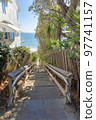 Stairs wooden railings and metal handrail bars heading to the beach at San Clemente, California 97741157