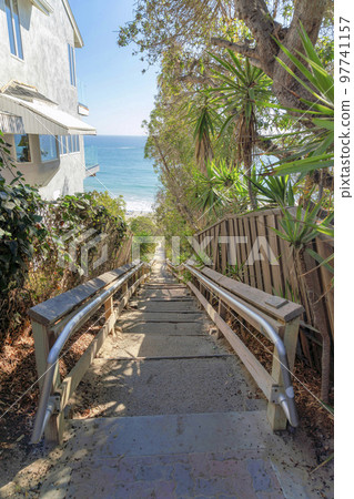 Stairs wooden railings and metal handrail bars heading to the beach at San Clemente, California Stairs wooden railings and metal handrail bars heading to the beach at San Clemente, California 97741157