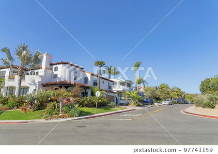 Intersection road in a residential area with mediterranean style houses at San Clemente, California Intersection road in a residential area with mediterranean style houses at San Clemente, California 97741159