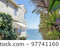 Outside a multi-storey beach house at San Clemente, California with a view of the blue sea 97741160
