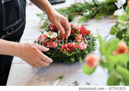 Flower arrangement using fresh flowers Handmade flower wreath Female flower designer 97741825