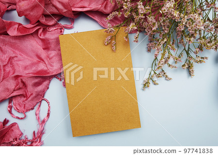 Empty invitation card mockup with flower and pink scarf on blue background 97741838