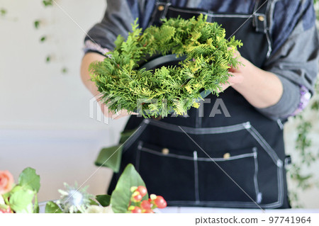Flower arrangement using fresh flowers Handmade flower wreath Female flower designer 97741964