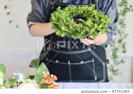 Flower arrangement using fresh flowers Handmade flower wreath Female flower designer Flower arrangement using fresh flowers Handmade flower wreath Female flower designer 97741965