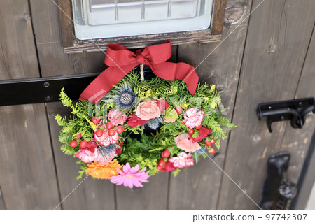 Gorgeous flower arrangement, flower wreath decorated with antique wooden arch door, flower designer Gorgeous flower arrangement, flower wreath decorated with antique wooden arch door, flower designer 97742307