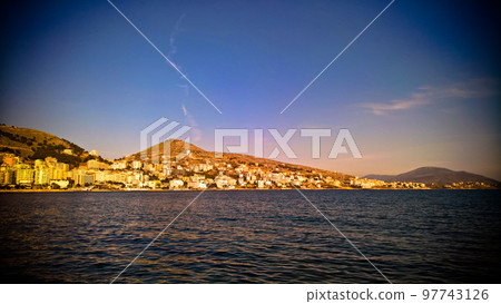 Sunset Panoramic view to Saranda city and bay of Ionian sea, Albania Sunset Panoramic view to Saranda city and bay of Ionian sea, Albania 97743126