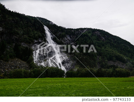 Panoramic view to Vidfossen waterfall at gronsdalslona river, Odda , Norway Panoramic view to Vidfossen waterfall at gronsdalslona river, Odda , Norway 97743133