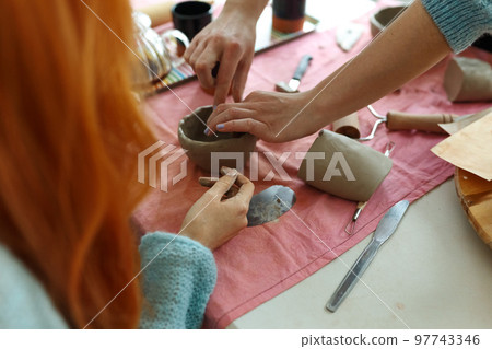 Pottery workshop class. A pottery crafts dish from a raw clay. Creating ceramics 97743346