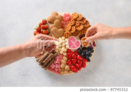 Charcuterie Valentines Day board with chocolate sweets. Charcuterie Valentines Day board with chocolate sweets. 97745312