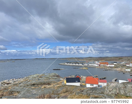 A view of red wooden houses on Vrango Archipelago island . A view of red wooden houses on Vrango Archipelago island . 97745992