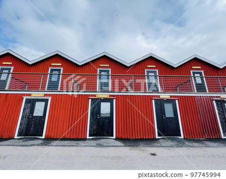 A view of red wooden houses on Donso Archipelago island . 97745994