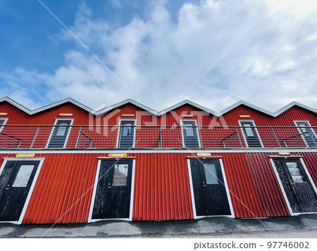 A view of red wooden houses on Donso Archipelago island . 97746002