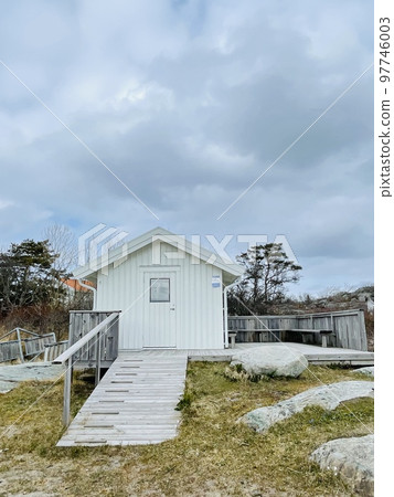 A view of red wooden houses on Vrango Archipelago island . A view of red wooden houses on Vrango Archipelago island . 97746003