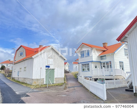 A view of red wooden houses on Vrango Archipelago island . A view of red wooden houses on Vrango Archipelago island . 97746004