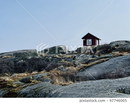 A view of red wooden houses on Vrango Archipelago island . A view of red wooden houses on Vrango Archipelago island . 97746005