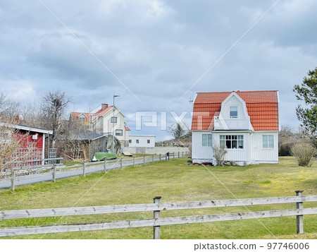 A view of red wooden houses on Vrango Archipelago island . A view of red wooden houses on Vrango Archipelago island . 97746006