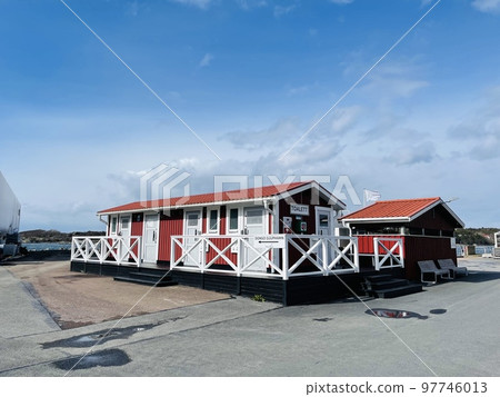 A view of red wooden houses on Donso Archipelago island . 97746013