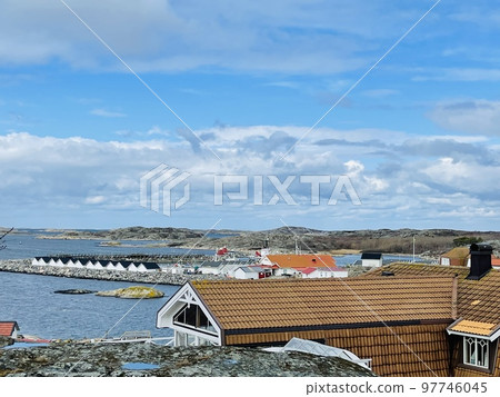 A view of red wooden houses on Vrango Archipelago island . 97746045