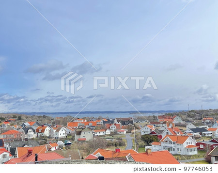 A view of red wooden houses on Vrango Archipelago island . A view of red wooden houses on Vrango Archipelago island . 97746053