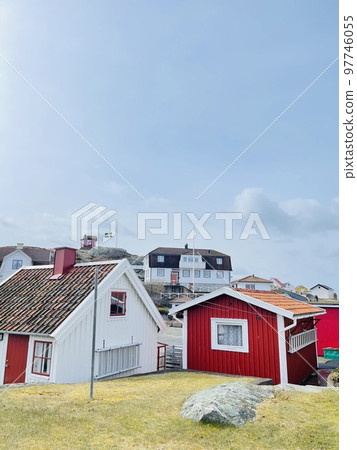 A view of red wooden houses on Vrango Archipelago island . A view of red wooden houses on Vrango Archipelago island . 97746055