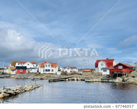 A view of red wooden houses on Vrango Archipelago island . A view of red wooden houses on Vrango Archipelago island . 97746057