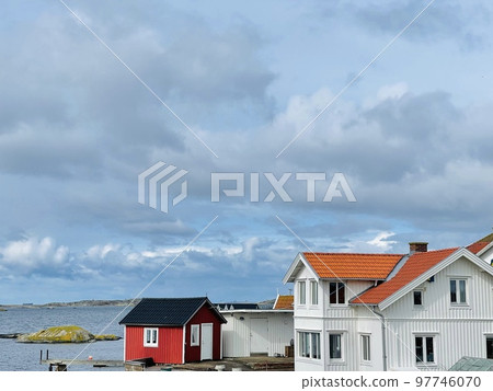 A view of red wooden houses on Vrango Archipelago island . 97746070