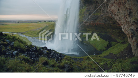 Close up of beautiful Seljalandfoss waterfall lit by sunset, Iceland 97746749