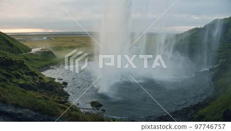 Backlit by sunset Seljalandfoss waterfall Iceland 97746757