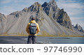 Rear view of man looking at Vestrahorn mountain in the background at Stokksnes beach Nature, travel and outdoor activity concept 97746990