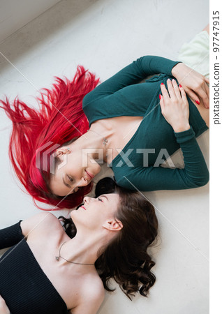 Top view of caucasian women lying and kissing. Top view of caucasian women lying and kissing. 97747915