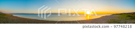 Mountain salt lake Issyk Kul.180 panorama of Issyk Kul mountain lake at sunset, azure and turquoise water color, sandy beach. 97748218